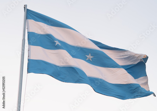 Flag of the city of Guayaquil, Ecuador, waving in the wind, selective focus on the star.