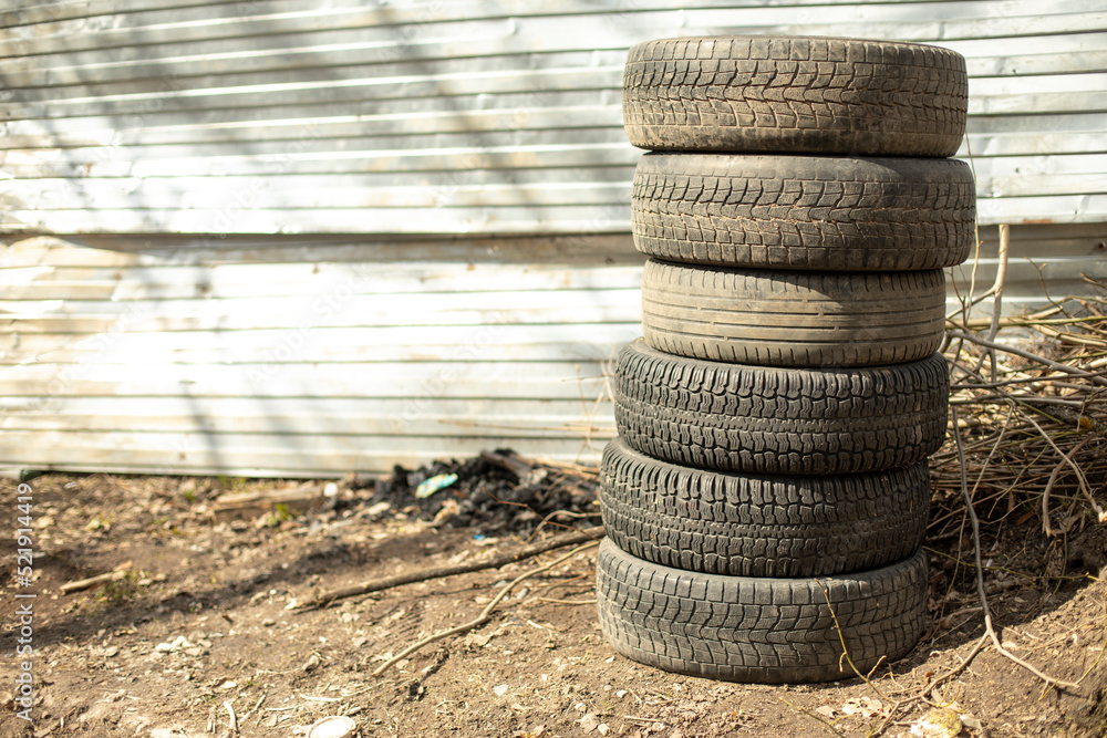Old wheels are on street. Car tires.
