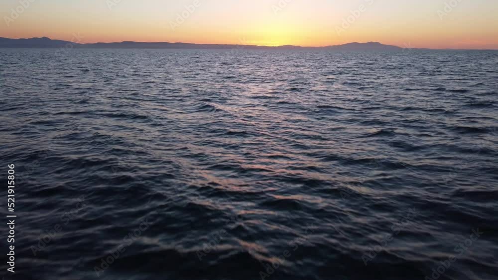 Flying over the sea with drone towards the sunset Flying over the sea with drone towards the sunset