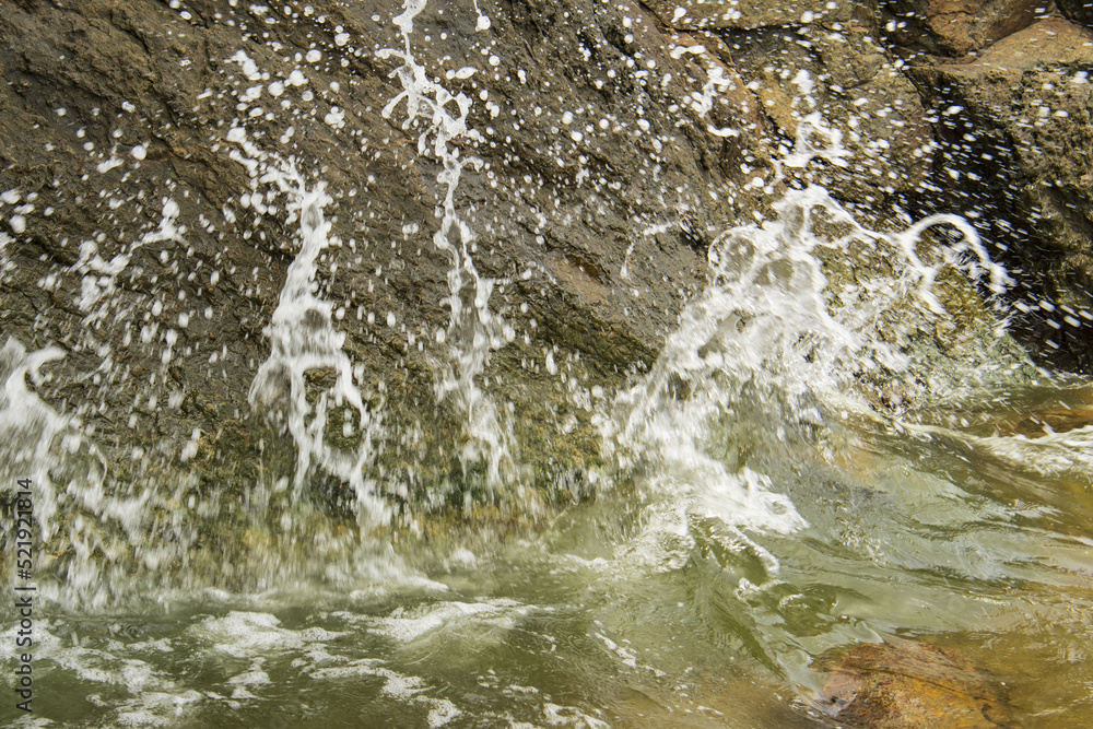 water splashes over rocks 