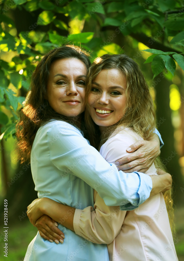 portrait of mother and daughter hugging, summer time, park portrait of mother and daughter hugging, summer time, park