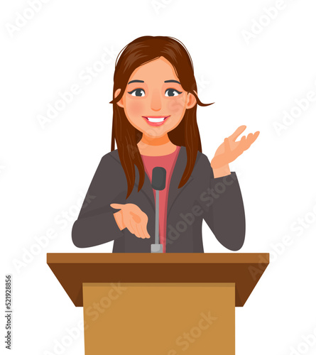 Young woman speaker giving speech standing at podium in a conference meeting hall