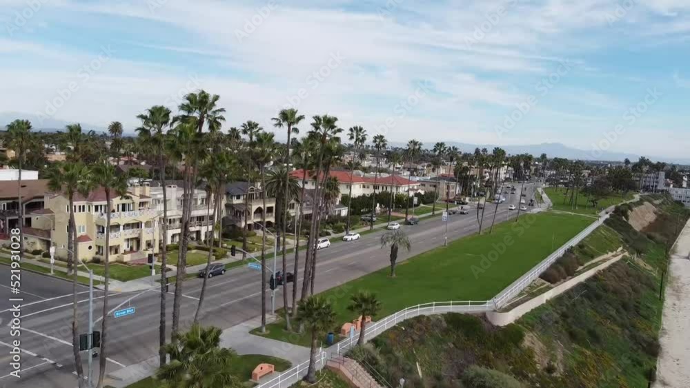 Aerial shot of street with moving cars along coastline. Long Beach, California. Aerial shot of street with moving cars along coastline. Long Beach, California.
