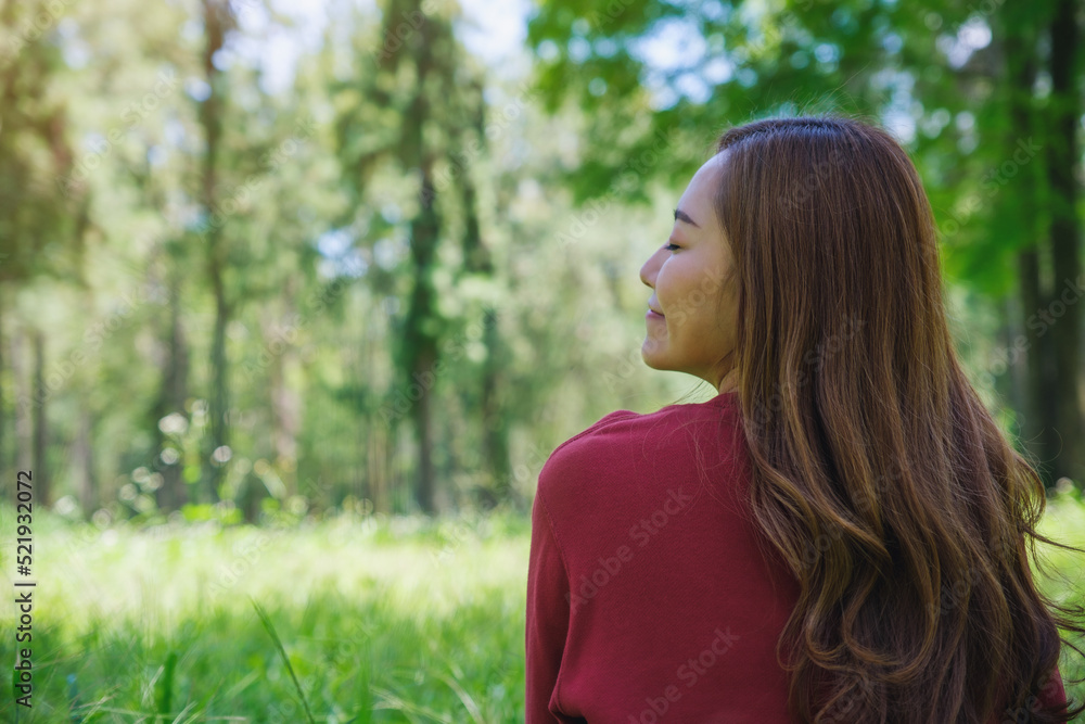 Portrait image of a young woman with closed eyes enjoying and relaxing in the park Portrait image of a young woman with closed eyes enjoying and relaxing in the park