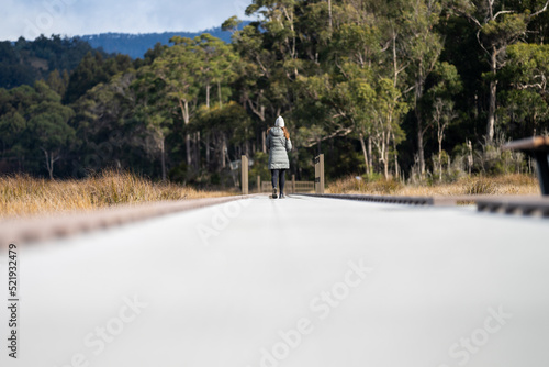 Girl walking on a boardwalk in Tasmania Australia 
