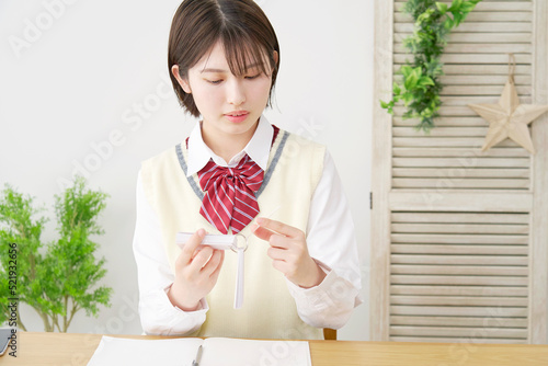 自宅で単語帳で勉強する女子高生 photo