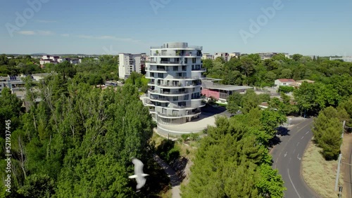 Wealthy apartment building in the middle of the green trees in Montpellier, France. photo