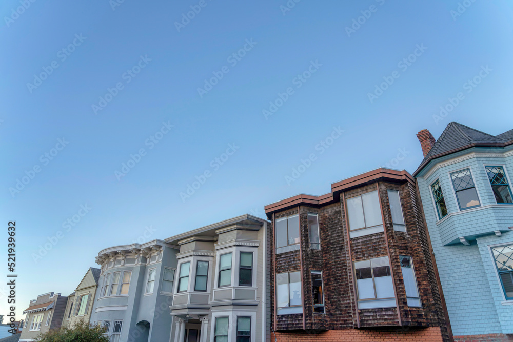 Townhouses in a row against the dusk sky in San Francisco, California