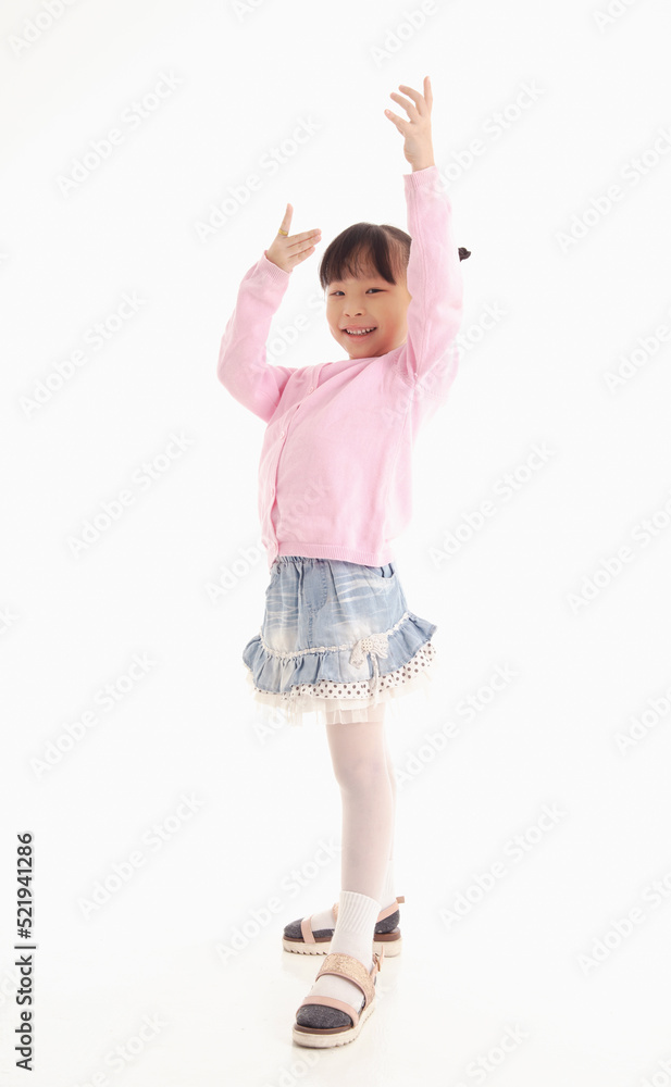 Full length of Little Asian girl standing and smiling over white background. Full length of Little Asian girl standing and smiling over white background.
