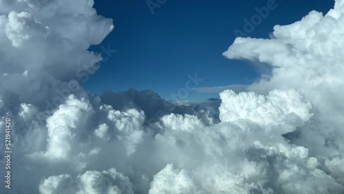 Impessive aerial view from a jet cockpit while maneuvering to a avoid bad weather cumulonimbus ahead. Pilot point of view. 4k 60 FPS. photo