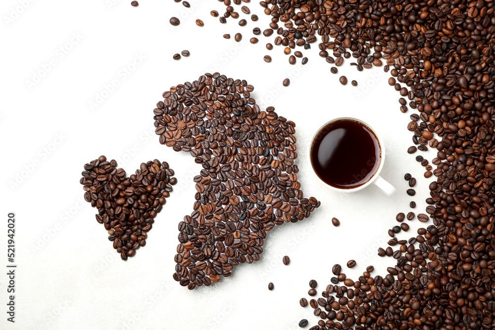 Naklejka premium African continent made of coffee beans on white textured background