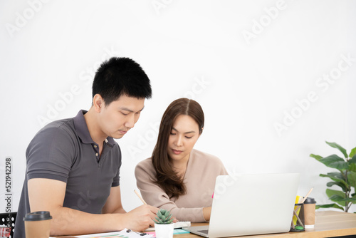 Young couple business people working with laptop at home office