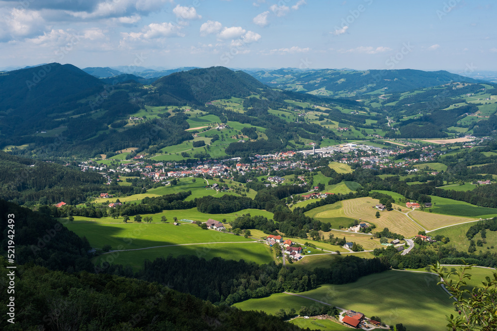 Lower Austria highlands landscape in summer, beautiful forests, meadows, farms, blue sky and puffy white clouds