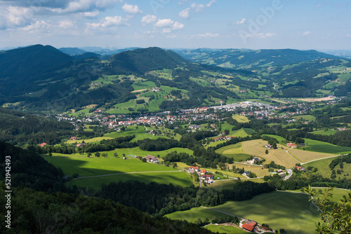 Lower Austria highlands landscape in summer, beautiful forests, meadows, farms, blue sky and puffy white clouds