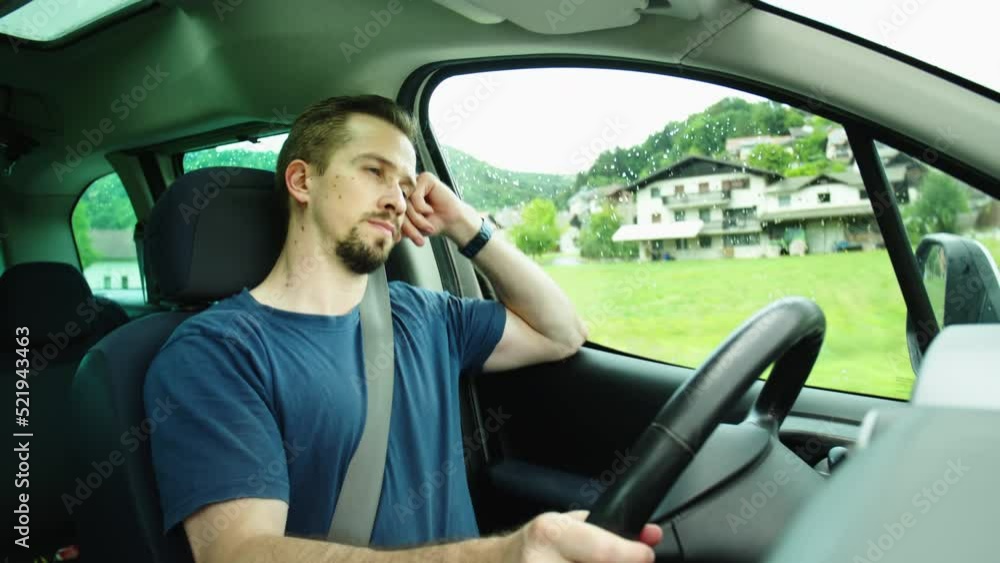 Thoughtful male car driver bored while driving in countryside 4K Thoughtful male car driver bored while driving in countryside 4K