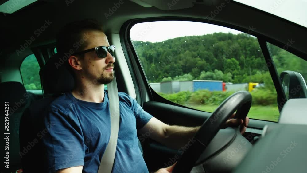 Male car driver with sunglasses looking surrounding while driving 4K Male car driver with sunglasses looking surrounding while driving 4K