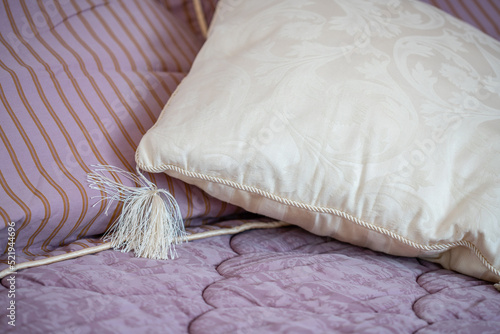 Fototapeta Naklejka Na Ścianę i Meble -  Decorative white pillow on a bed