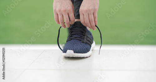 woman runner tying running shoes