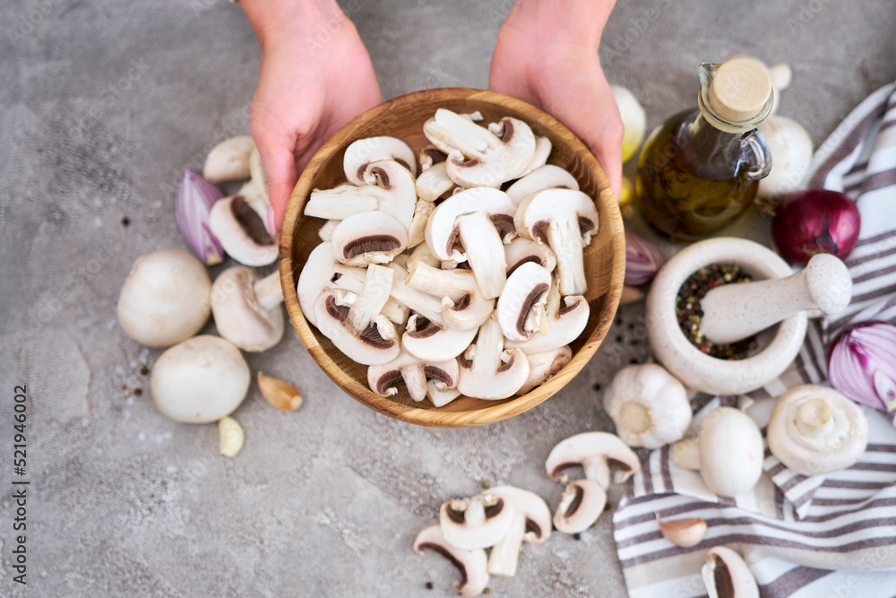 champignon mushrooms in wooden bowl at domestic kitchen