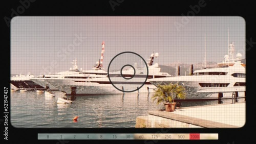Retro movie camera with sea port of Tivat, is a coastal town in Montenegro, located in the Bay of Kotor. Summer landscape with mountain and clear blue sky