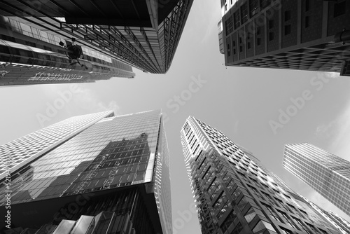 Low angle view of modern office buildings in Hong Kong  Black and white