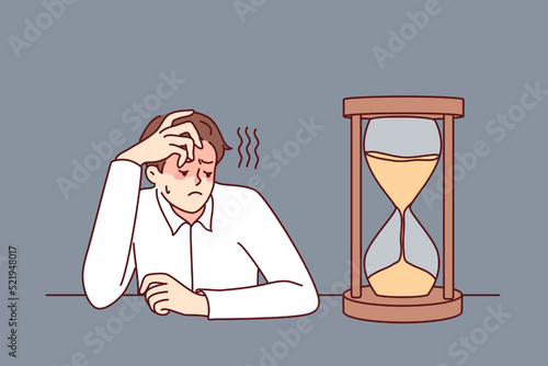 Exhausted businessman looking at hourglass feel bored and overwhelmed. Tired male employee look at sand clock wait for working day end. Vector illustration. 