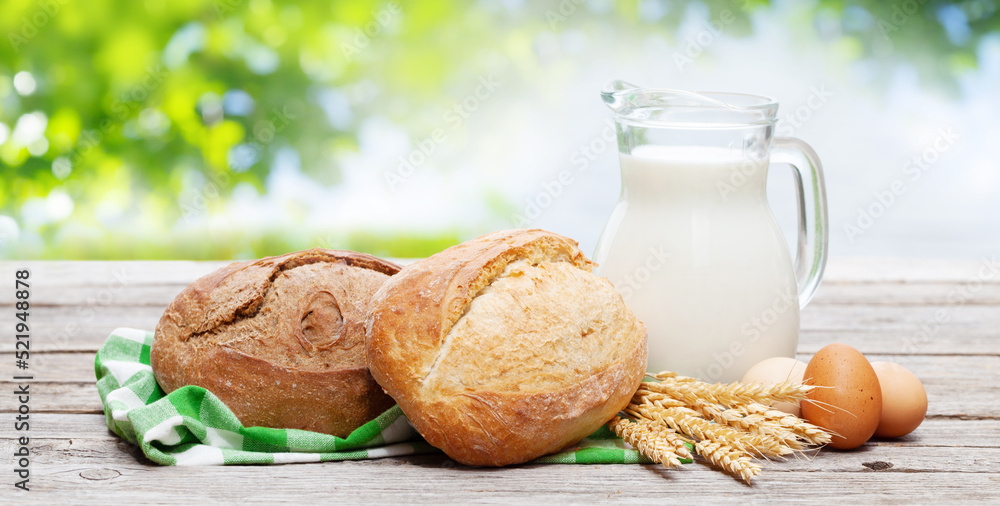 Homemade bread and milk on wooden table