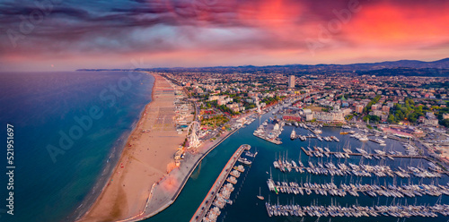 Panoramic summer view from flying drone of Libera Rimini public beach. Incredible evening scene of Italy, Europe. Spectacular sunset on Adriatic coast. Vacation concept background. photo