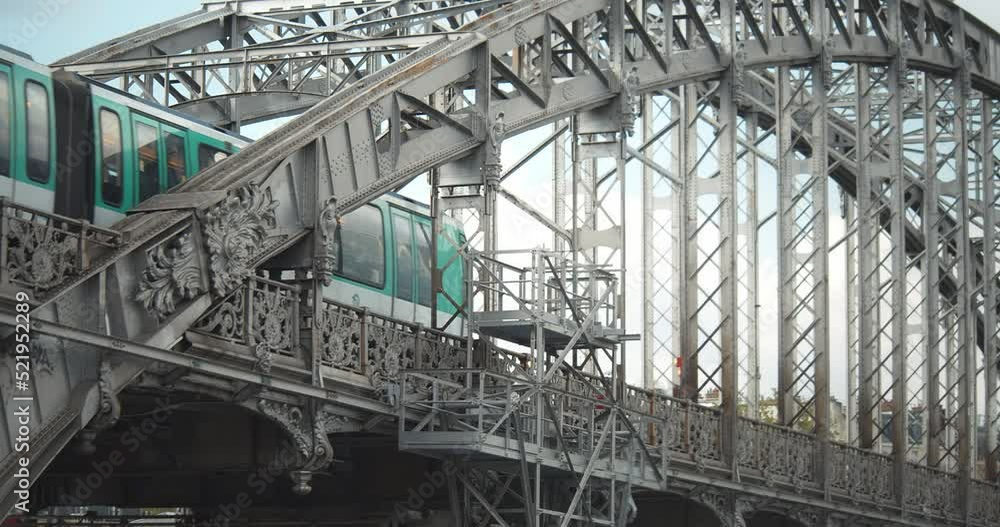 Closeup green and white aerial metro crossing a steel bridge over the Seine. Parisian subway going over Austerlitz viaduct. Closeup green and white aerial metro crossing a steel bridge over the Seine. Parisian subway going over Austerlitz viaduct.