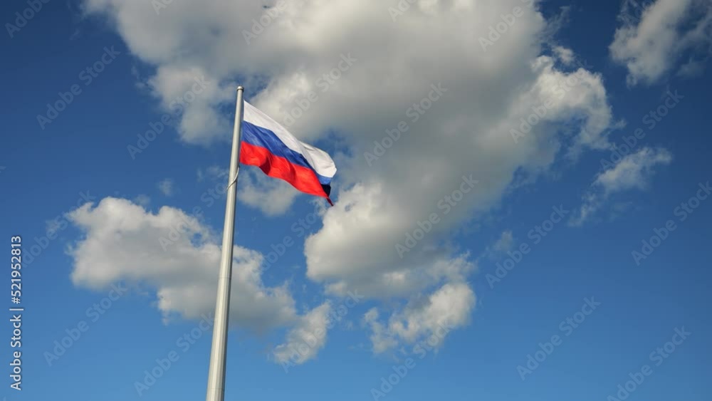 the flag of russia against the background of the blue sky flutters in the wind the flag of russia against the background of the blue sky flutters in the wind