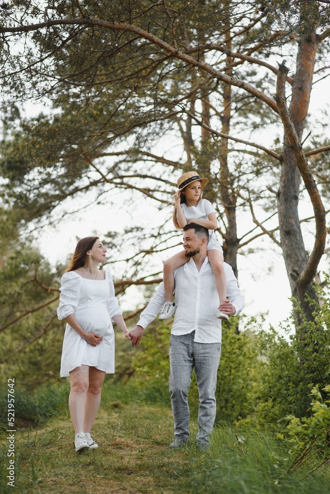 Fototapeta premium Pregnant woman with her family looking happy