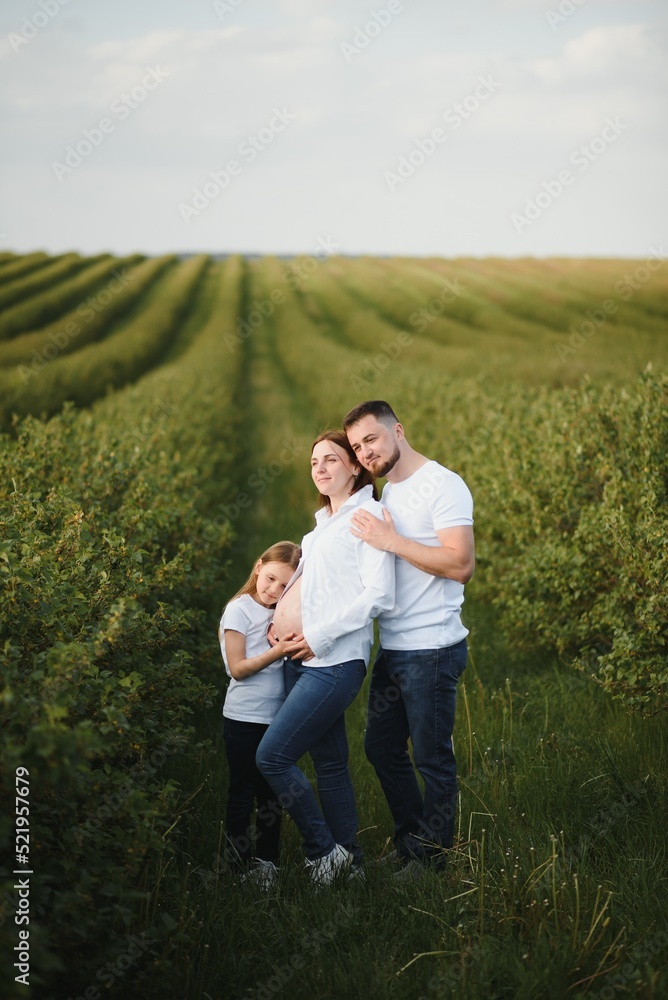 Pregnant woman with her family looking happy Pregnant woman with her family looking happy