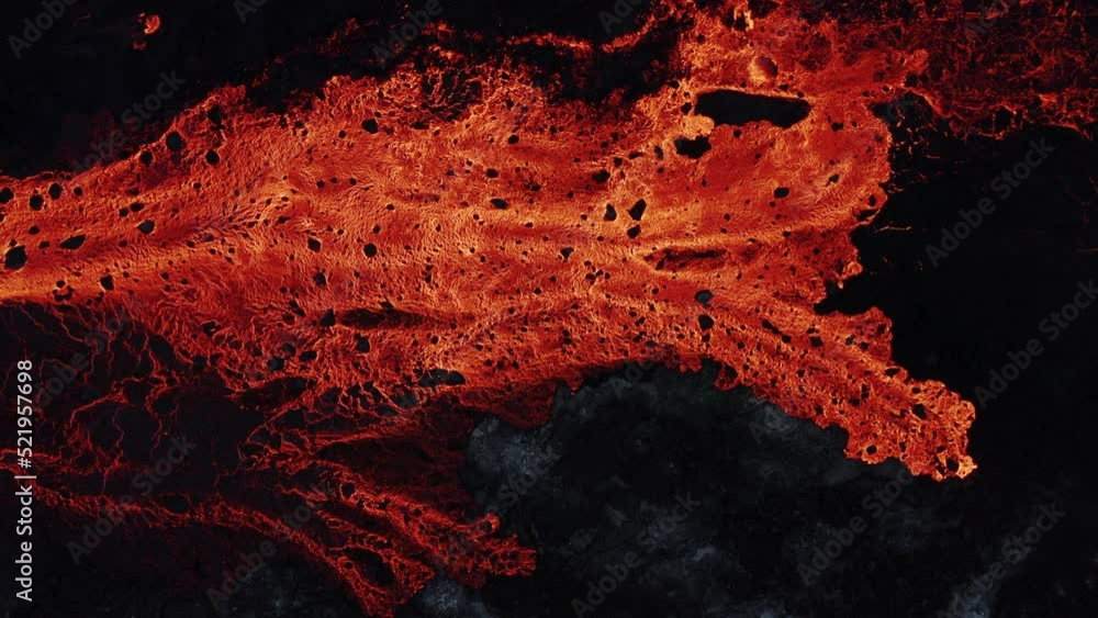 Fiery red burning lava on earth surface, effusive eruption, top down Fiery red burning lava on earth surface, effusive eruption, top down