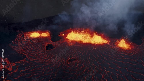 2022 Meradalir effusive eruption at night, hot glowing lava spewing from ground, aerial