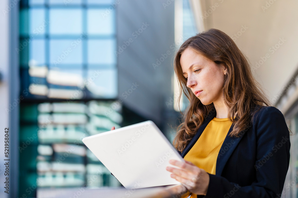 Businesswoman with brown hair using tablet PC Businesswoman with brown hair using tablet PC