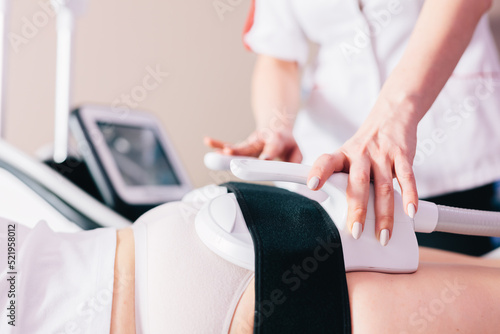 Woman getting ems treatment on buttocks to burn fat, build muscles and remove cellulite photo