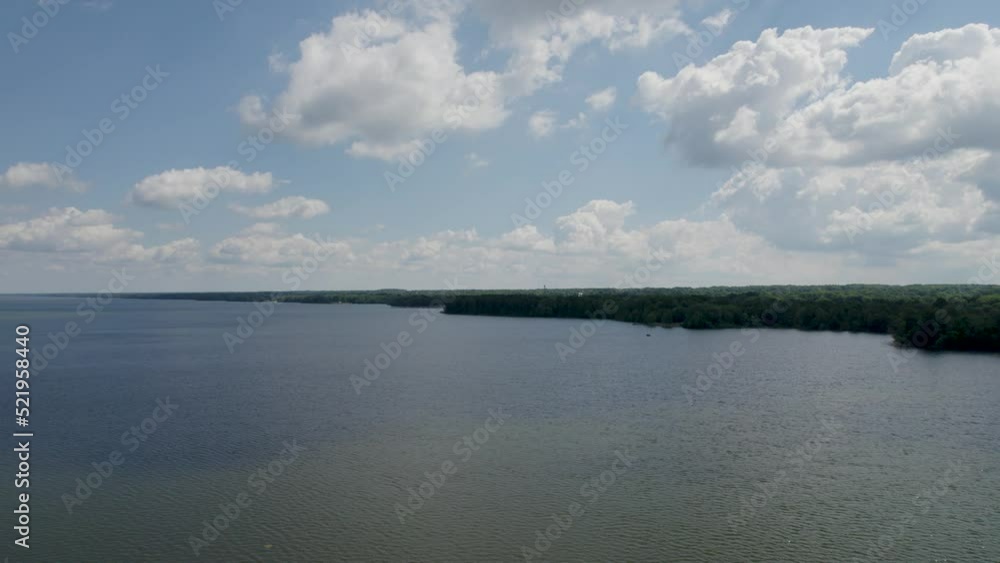 Aerial view of the rushing Mosquito Lake captured by drone with fluffy clouds and a stunning blue sky. Aerial view of the rushing Mosquito Lake captured by drone with fluffy clouds and a stunning blue sky.