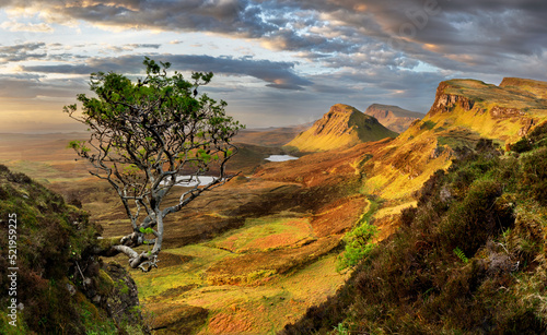 Scotland - Beautiful summer sunrise mountain landscape over the Quiraing and it's steep winding mountain road, on the Isle of Skye, UK