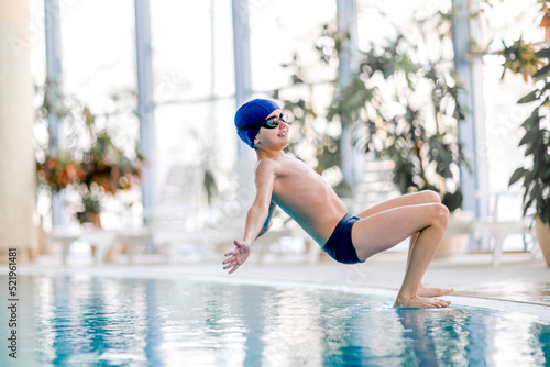 Boy in the swimming pool. Training sessions on the water.