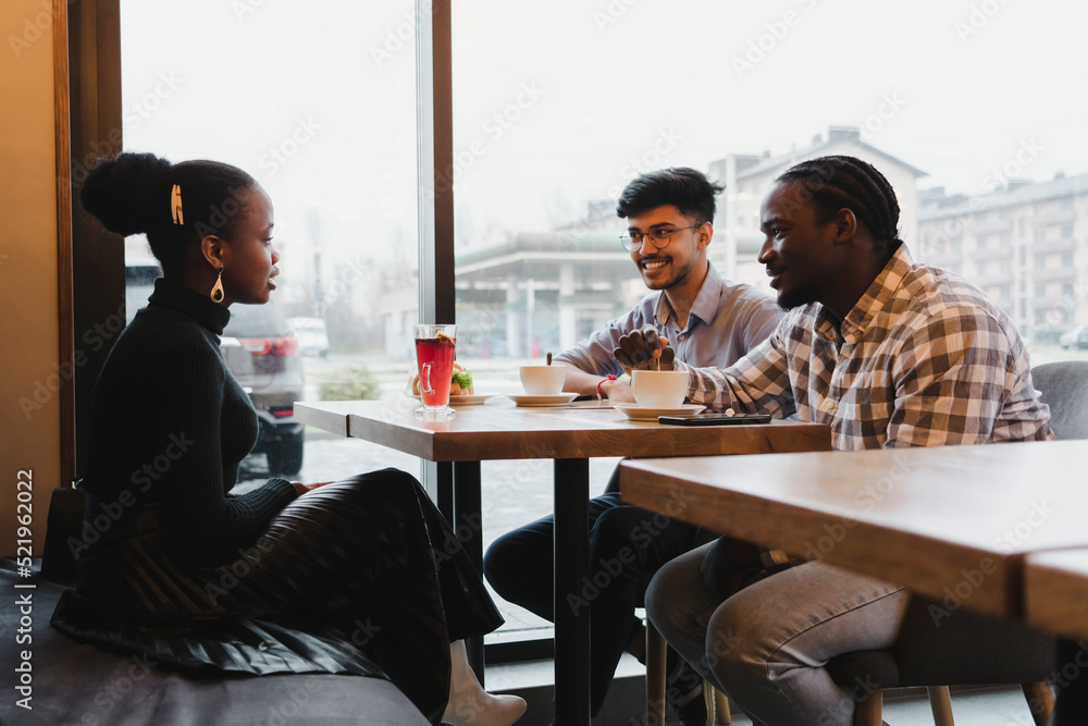 Young friends spending time together in cafe Young friends spending time together in cafe