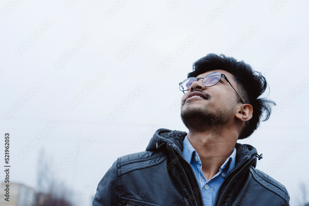 Happy man wearing eyeglasses looking up at sky Happy man wearing eyeglasses looking up at sky