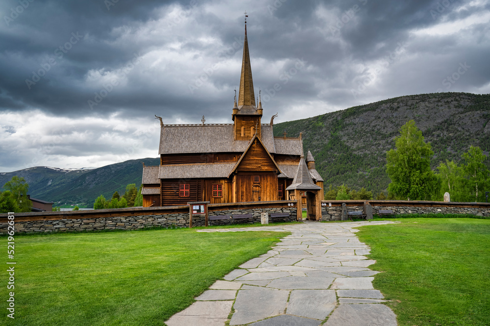 Norway, Innlandet, Lom, Footpath in front of historic stave church