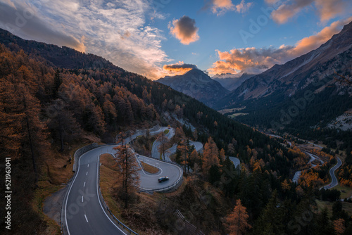 Switzerland, Grisons, Sankt Moritz, View of Maloja Pass road at autumn dusk photo