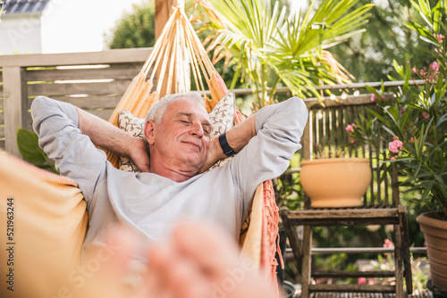 Senior man napping in hammock