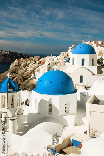 santorini churches with blue domes an white buildings blue sky and steps down white and blue greece