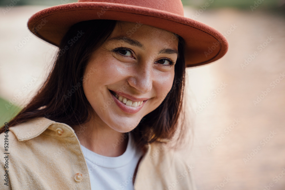 Happy woman wearing hat in park Happy woman wearing hat in park