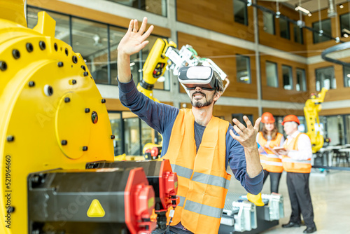 Industrial worker in robotics factory using virtual reality simulator photo