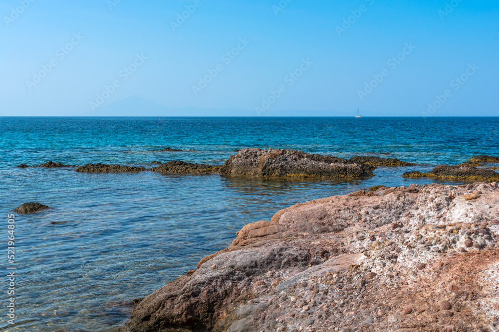 Clean blue sky with ocean rock in the foreground