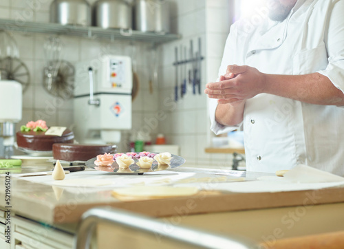 Confectioner preparing marzipan at kitchen photo