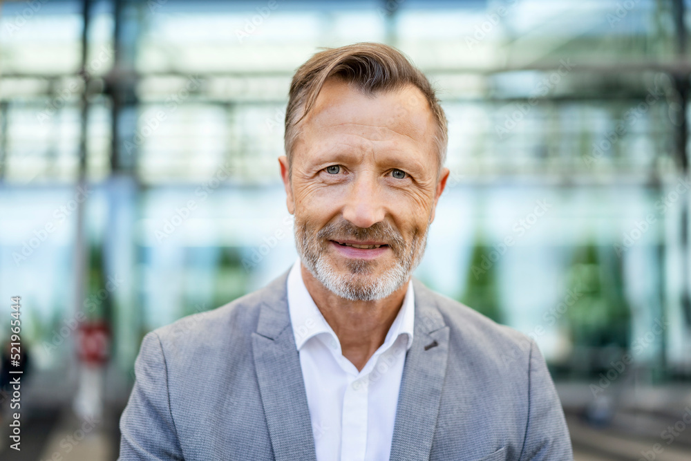 Smiling mature businessman in gray blazer Smiling mature businessman in gray blazer